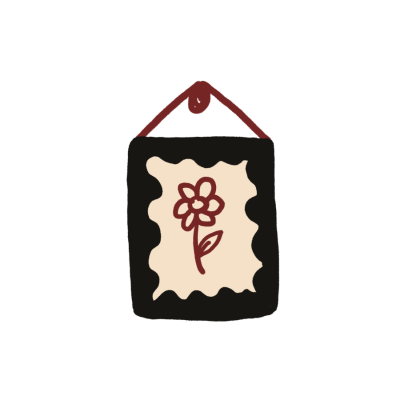 A square black wall hanging or plaque with a cream scalloped center panel featuring a simple red flower illustration, suspended by a red cord against a plain white background.
